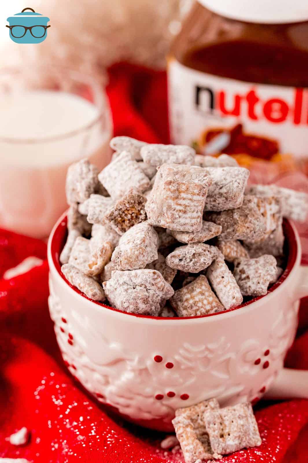 Nutella Puppy Chow in pink mug with Nutella container in background.