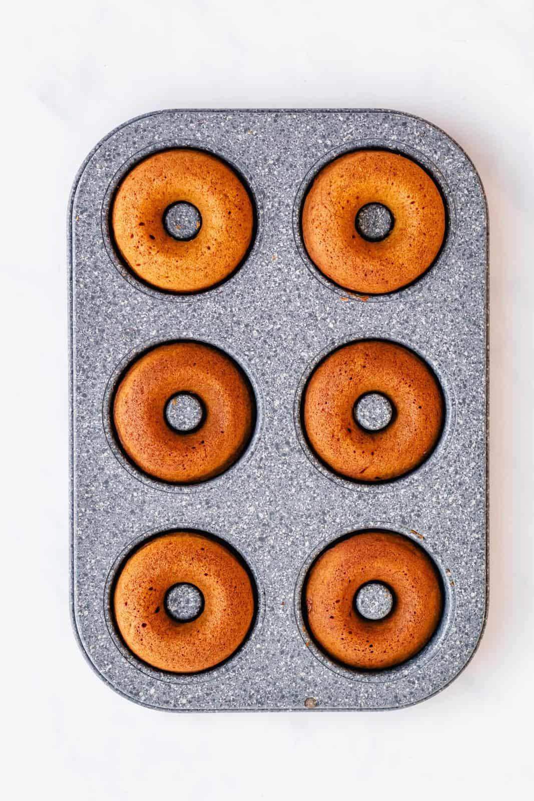 Baked donuts in muffin pan.