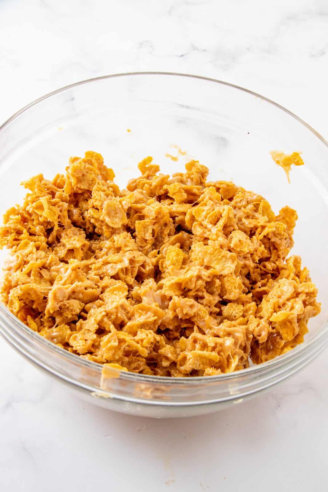 Corn syrup and peanut butter mixture poured over cornflakes and mixed together.
