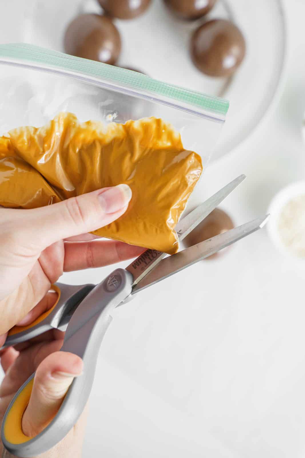 Melted peanut butter candy melts added to bag with tip being cut off.