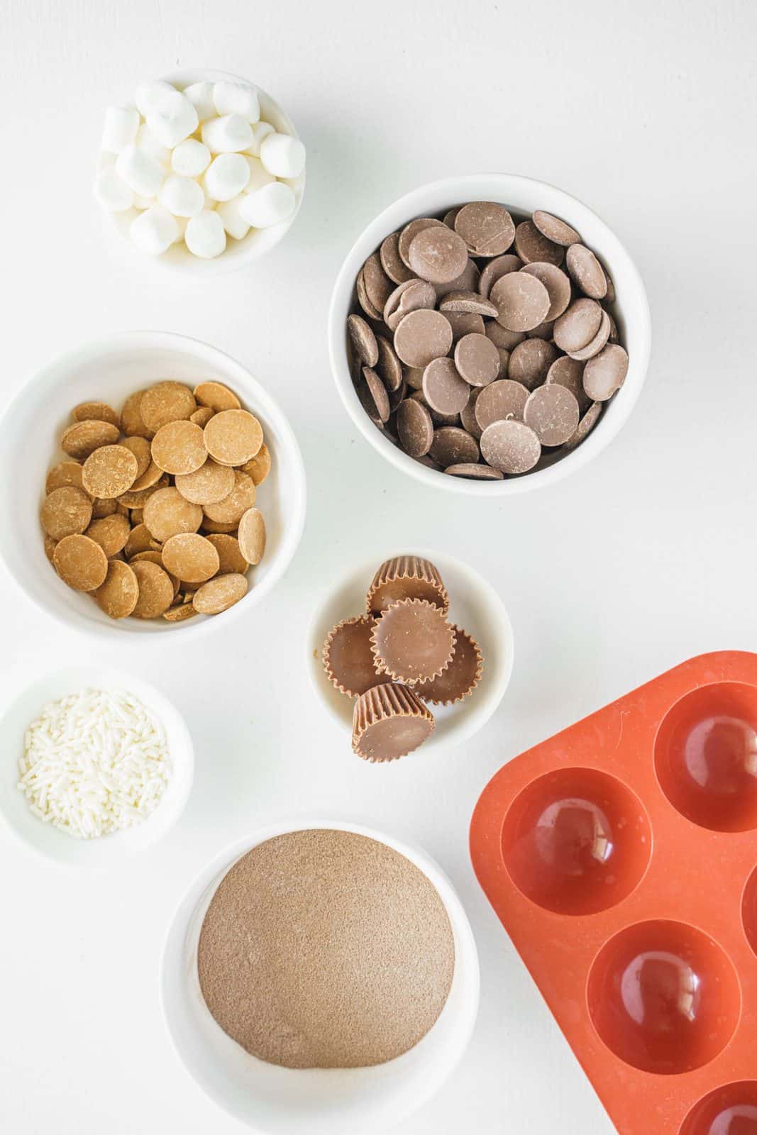 Ingredients needed: chocolate candy melts, hot cocoa, mini marshmallows, mini peanut butter cups, peanut butter candy melts and sprinkles.