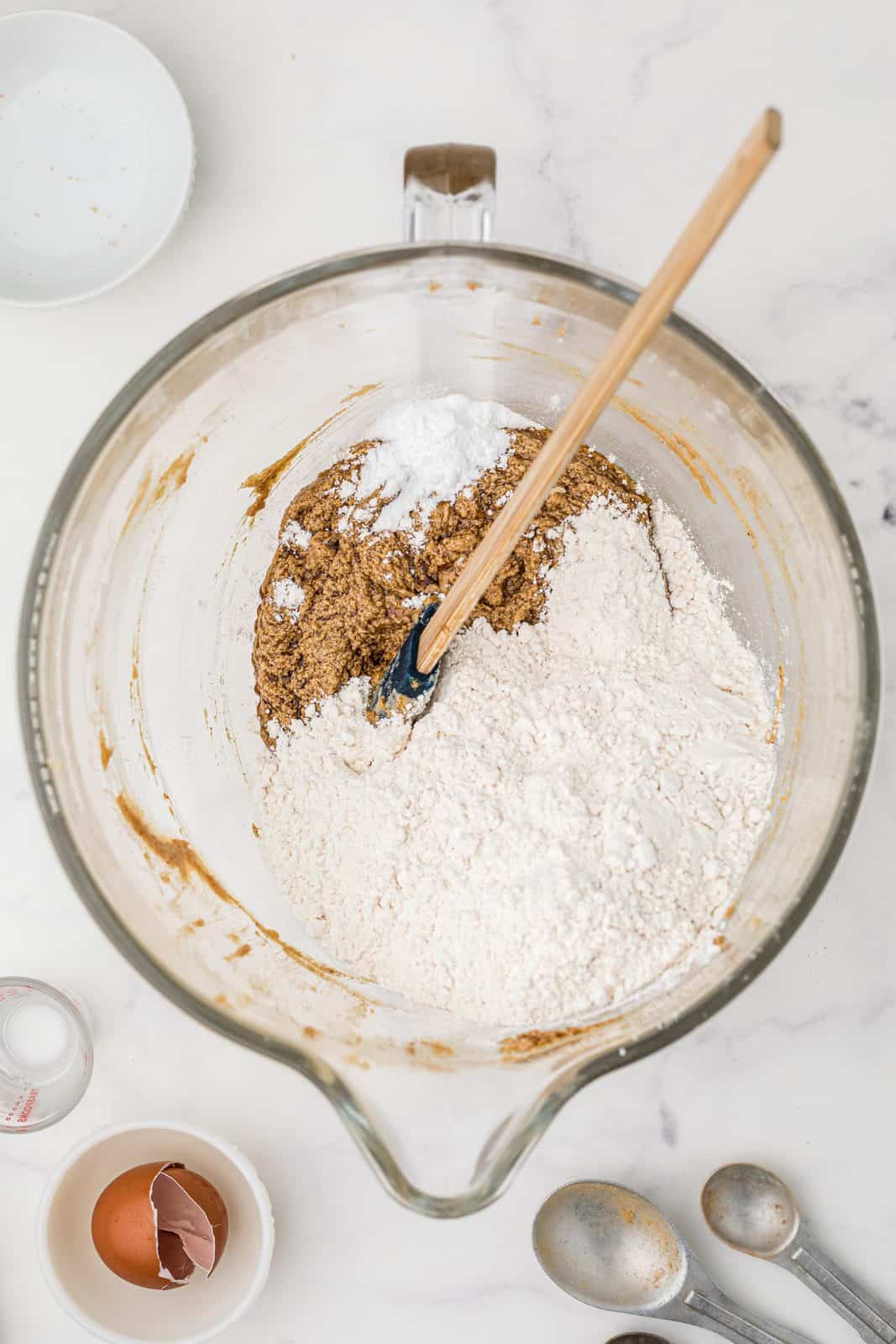 Flour added to bowl of stand mixer with other ingredients.