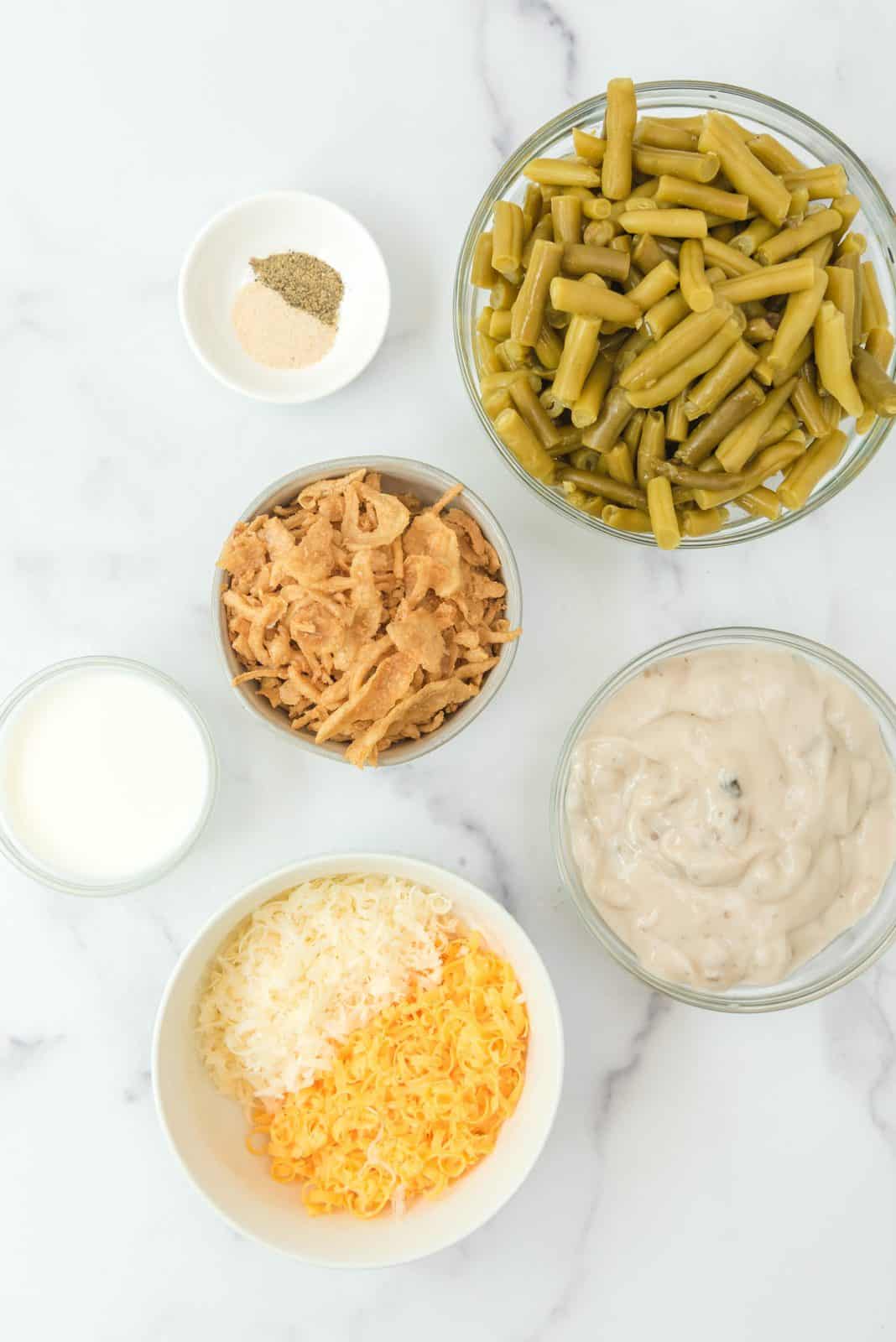 Ingredients needed: cream of mushroom soup, milk, onion powder, pepper, green beans, parmesan cheese, cheddar cheese and french fried onions.