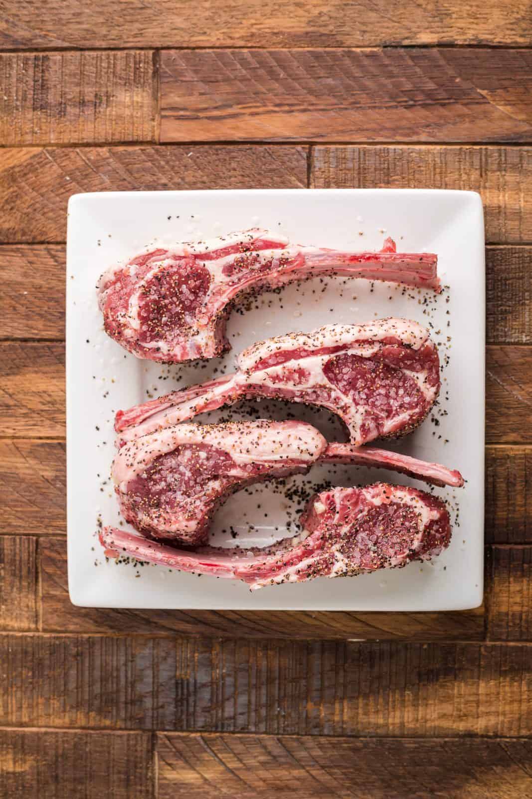 Lamb chops sprinkled with salt and pepper.
