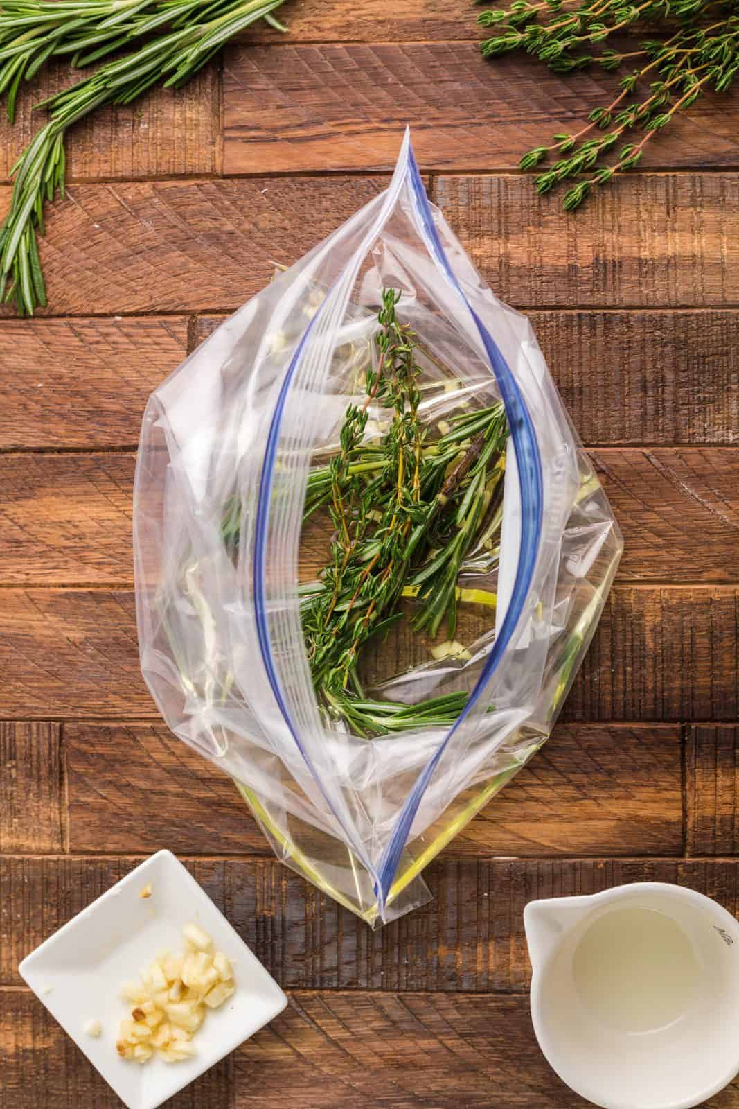 Grapeseed oil, garlic rosemary sprigs added to ziptop bag.