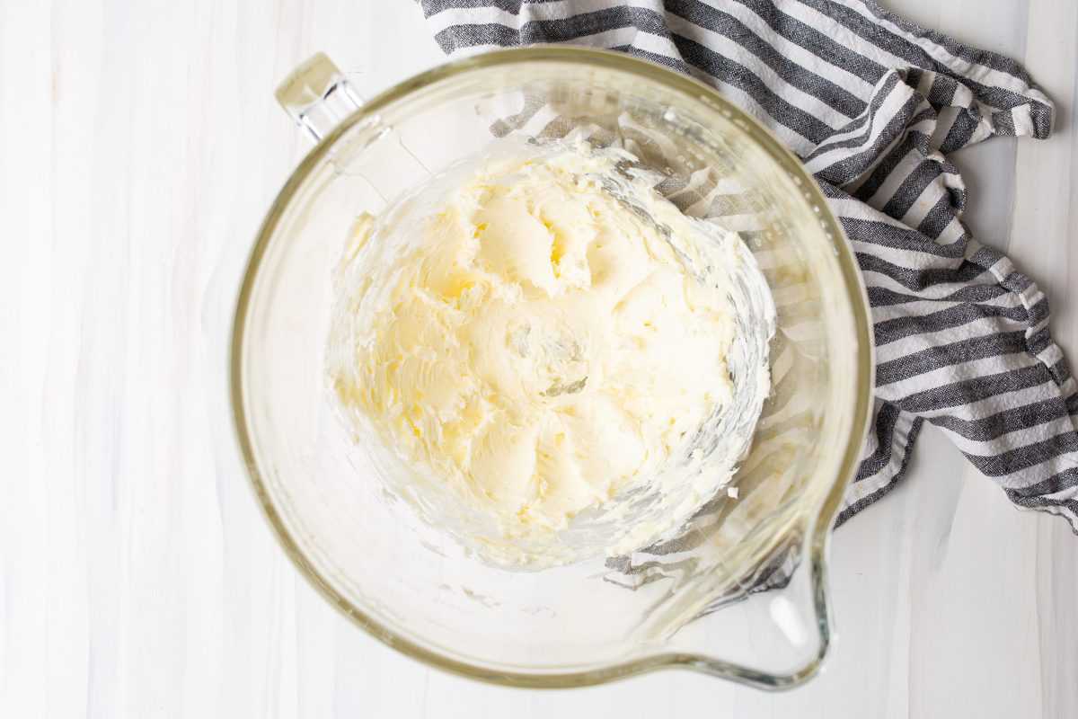 Butter and cream cheese mixed together in bowl of stand mixer.