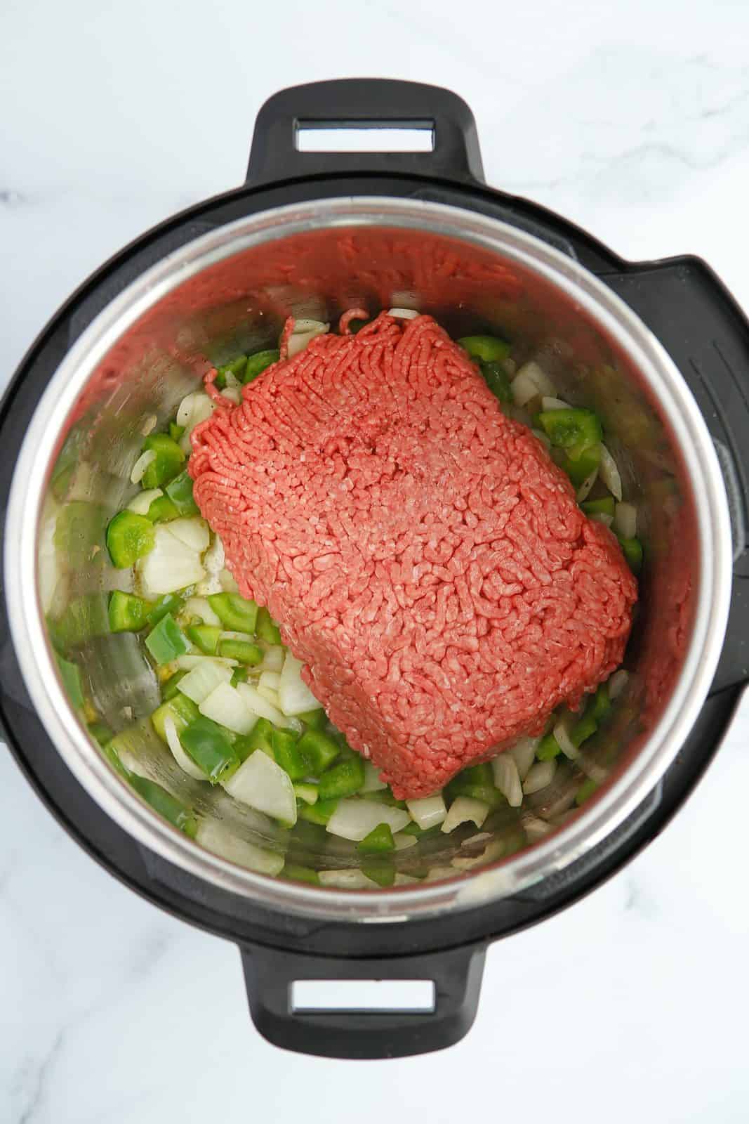 Onions, pepper and ground beef in instant pot.