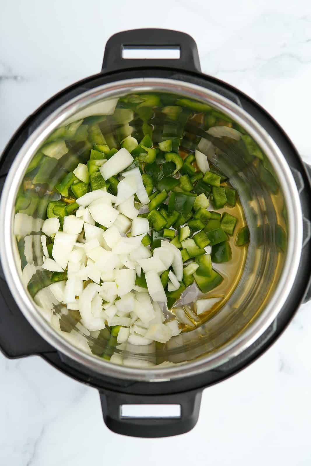Oil, onions and green pepper in instant pot.