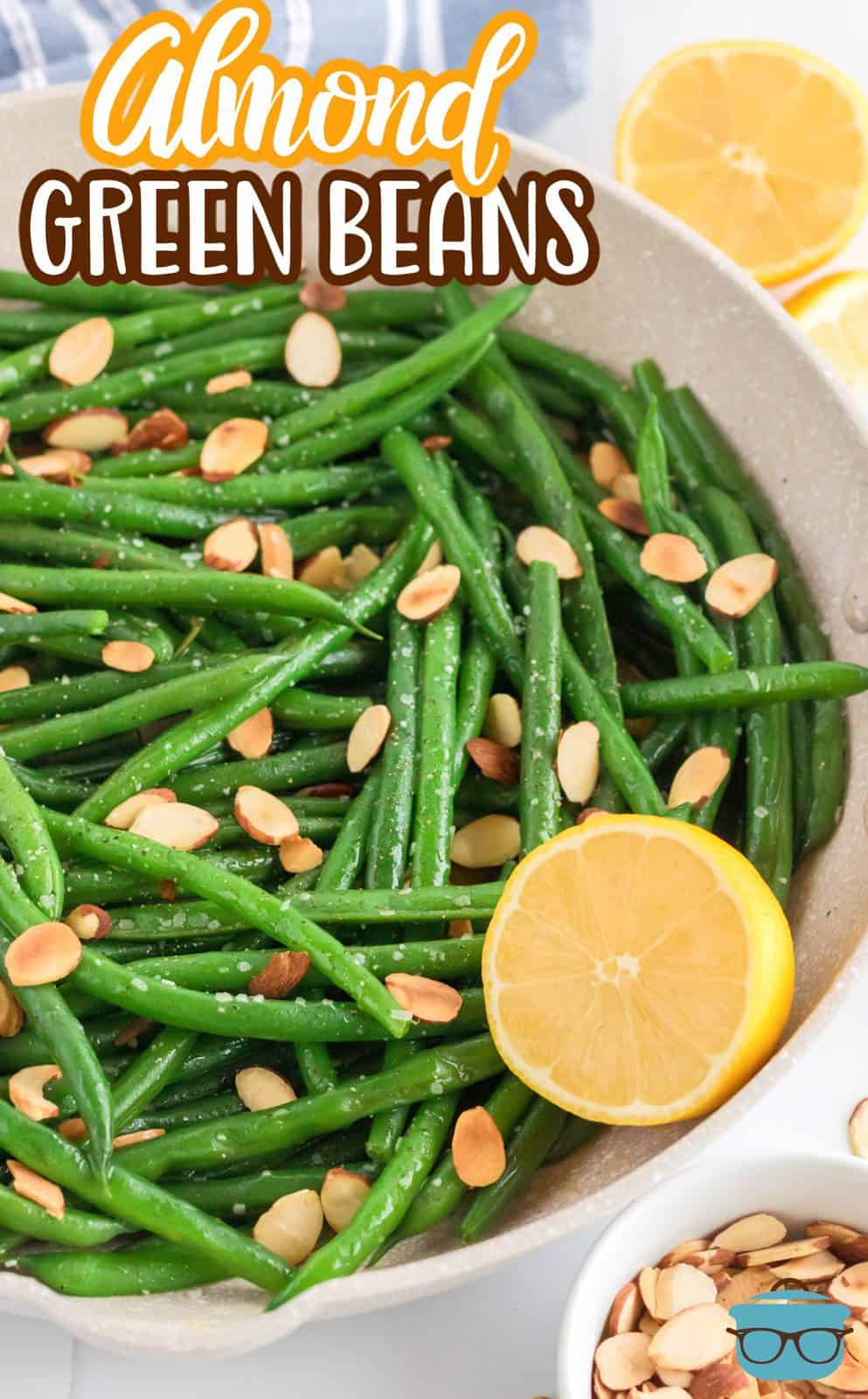 Pinterest image of finished Almond Green Beans with half a lemon.