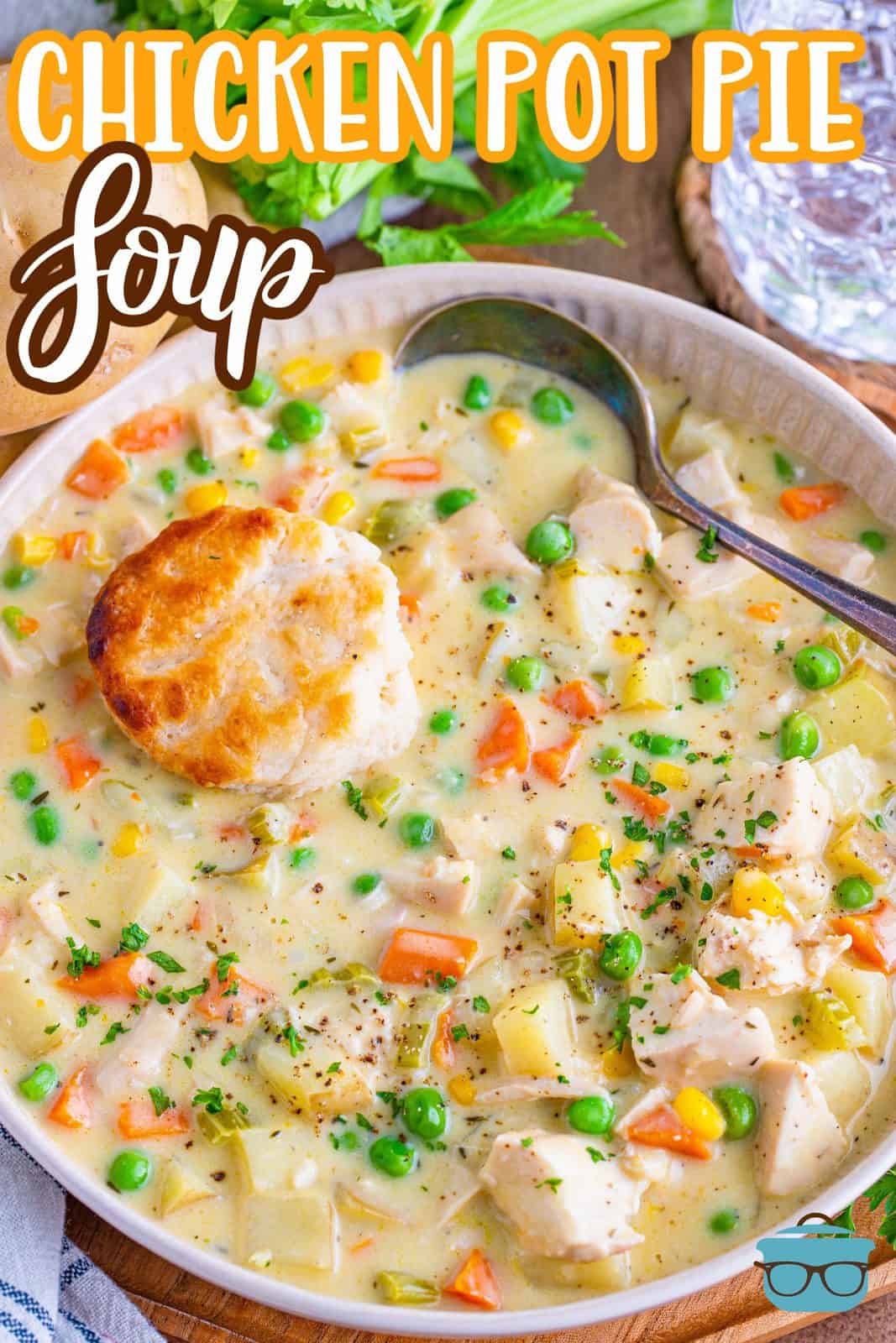 Pinterest image of Chicken Pot Pie Soup in bowl with biscuit and spoon.