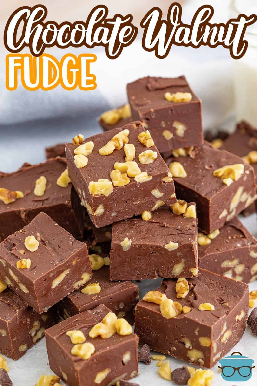 Pinterest image of Chocolate Walnut Fudge stacked whosing off walnuts.