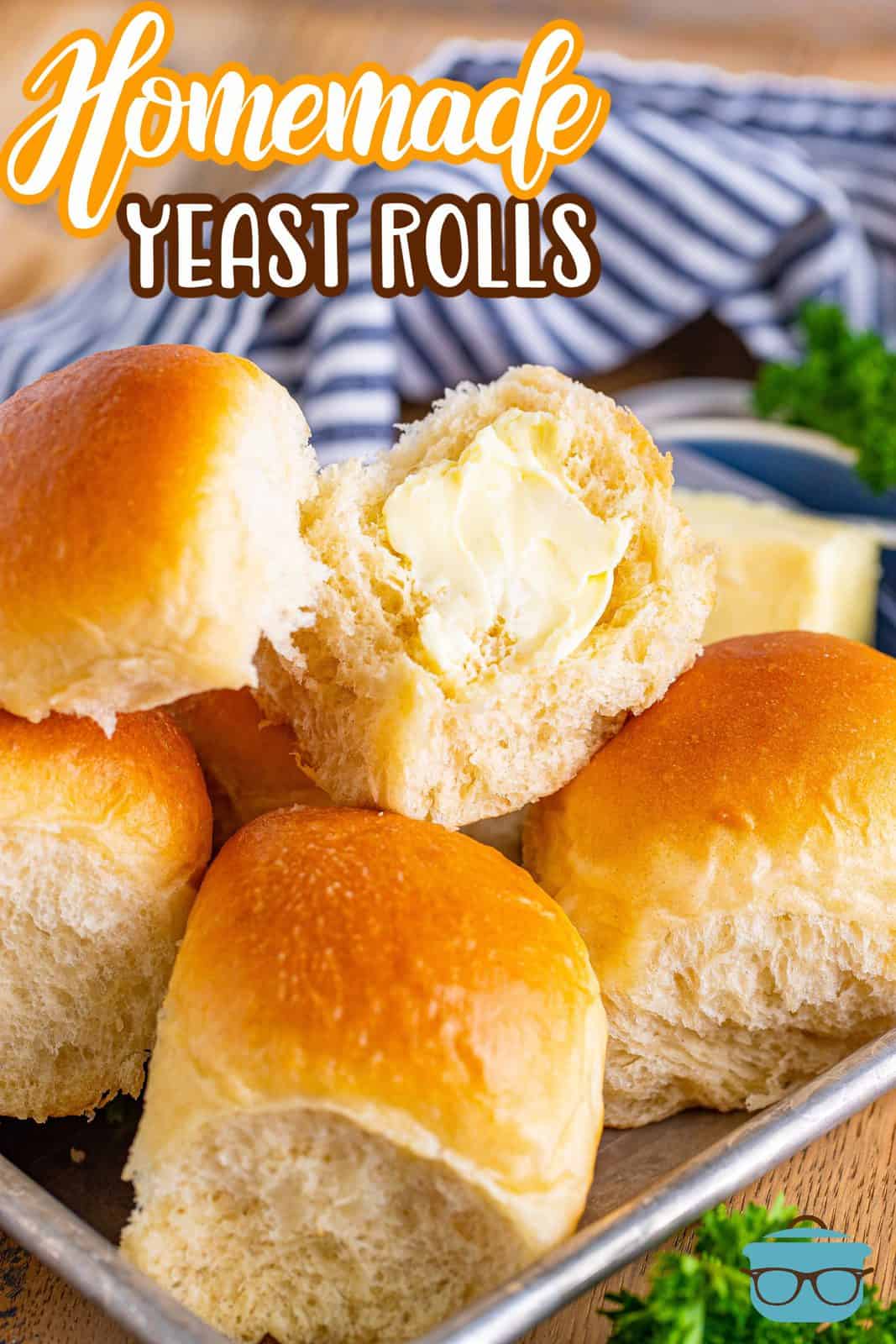 Pinterest image of Homemade Yeast Rolls on tray with one cut open spread with butter.