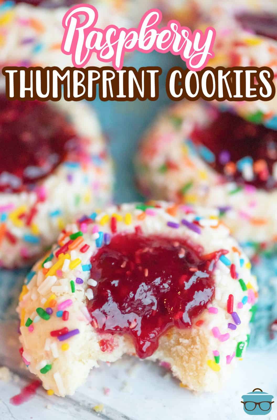 Pinterest image of Raspberry Thumbprint Cookies overhead with bite taken out of one.