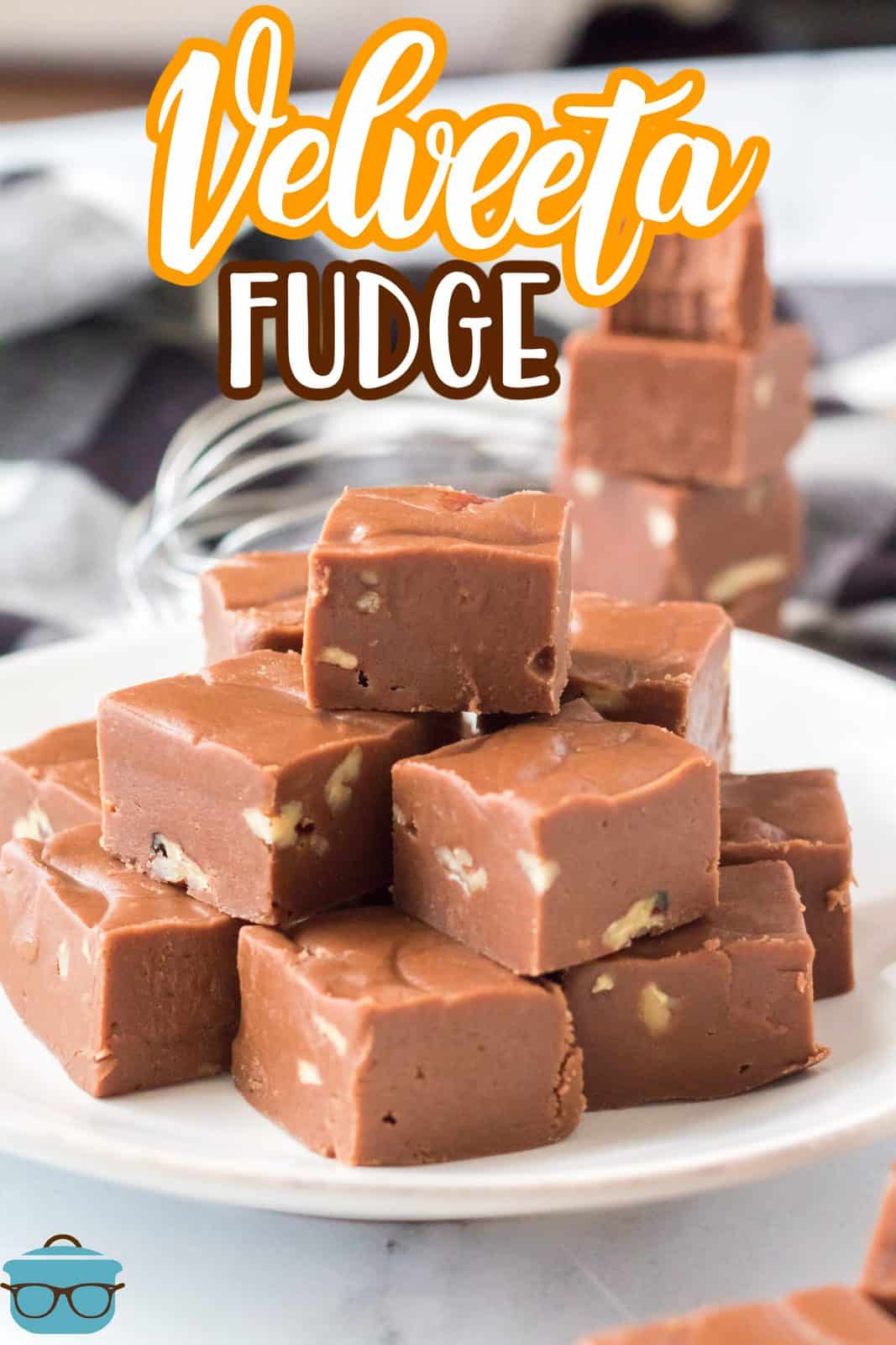 Pinterest image of Velveeta Fudge stacked on plate with more stacked behind it.
