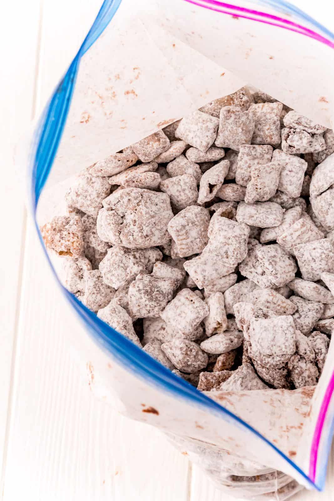 Chex mixture in ziptop bag covered with powdered sugar.