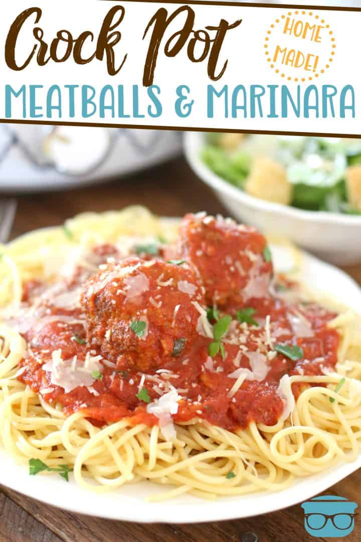 A plate topped with spaghetti noodles with marinara and meatballs and freshly shaved Parmesan cheese. 