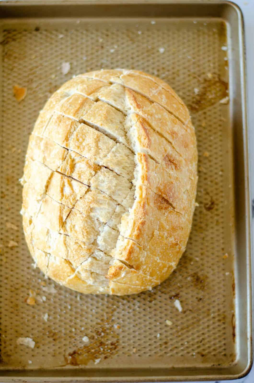 Bread cut on baking sheet.
