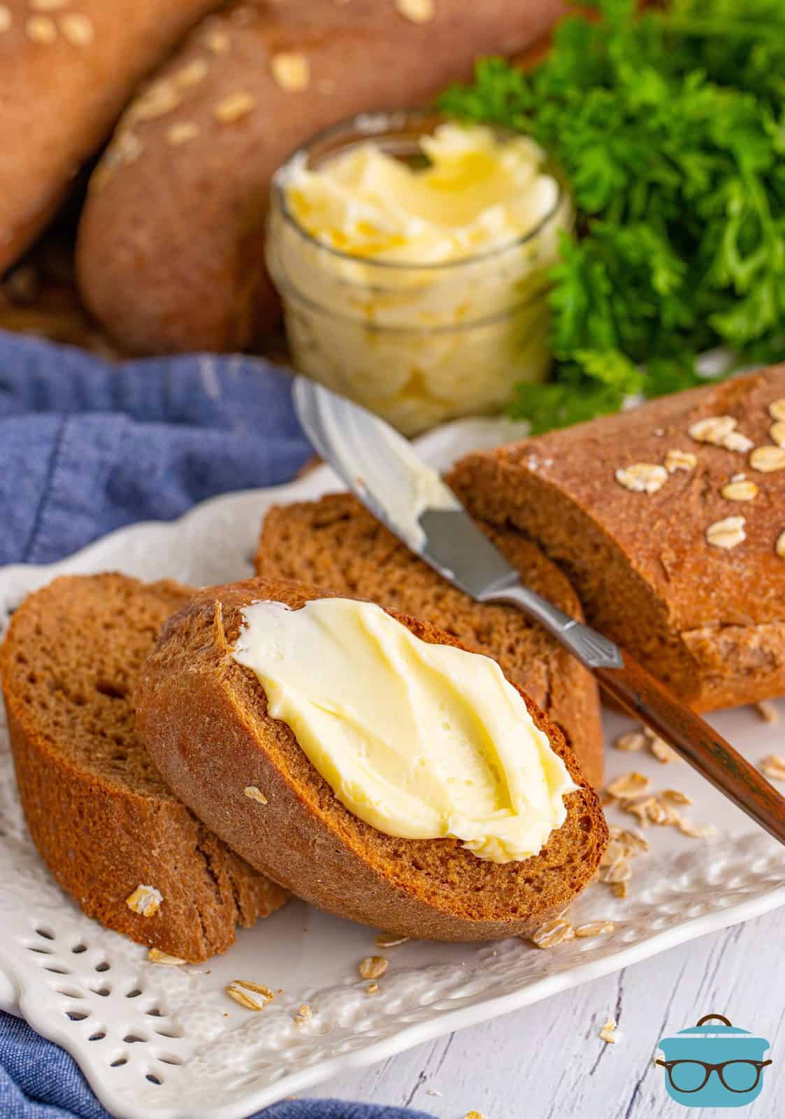 Butter spread on slice of Cheesecake Factory Brown Bread.