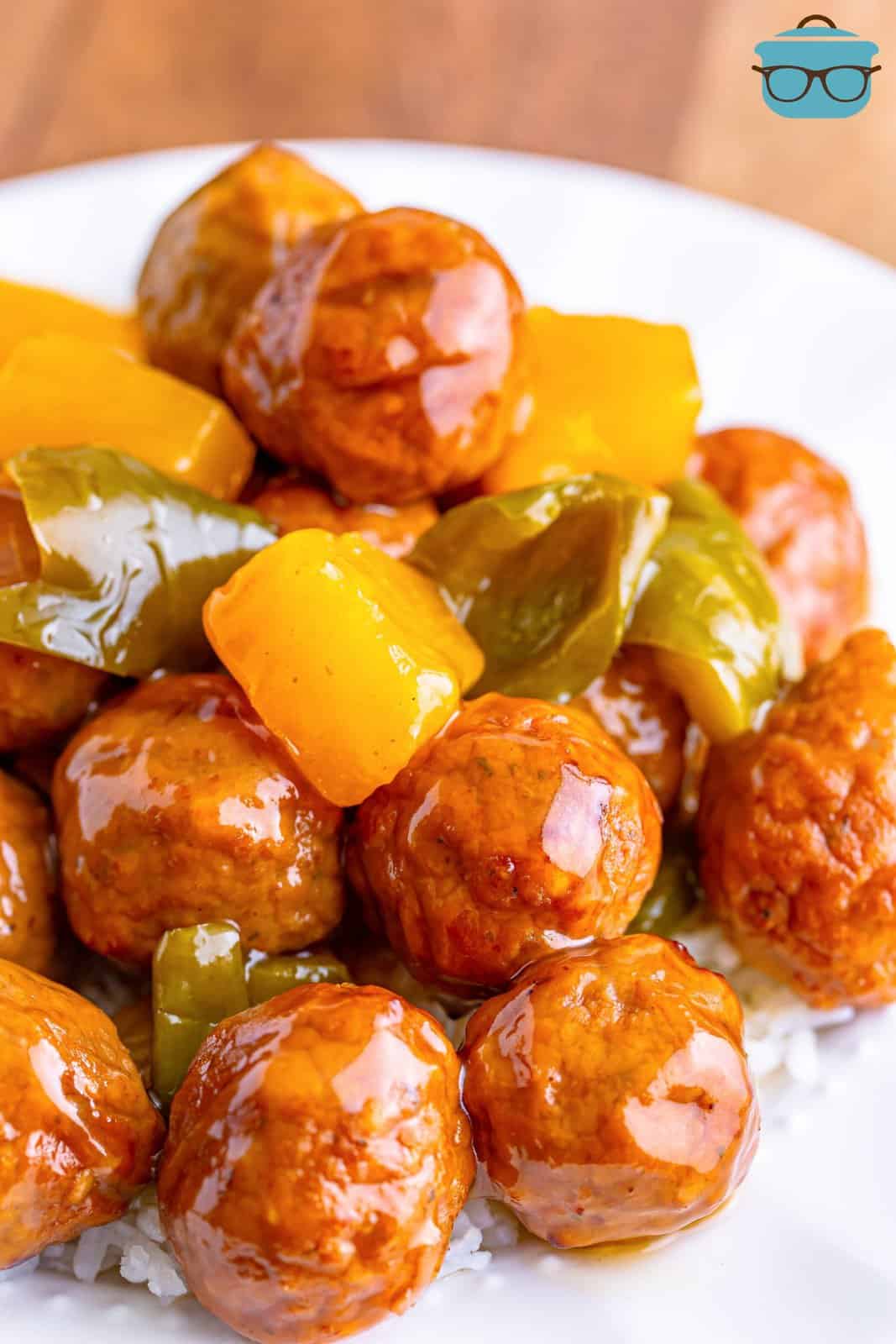 closeup photo pf sweet and sour meatballs on white rice. 
