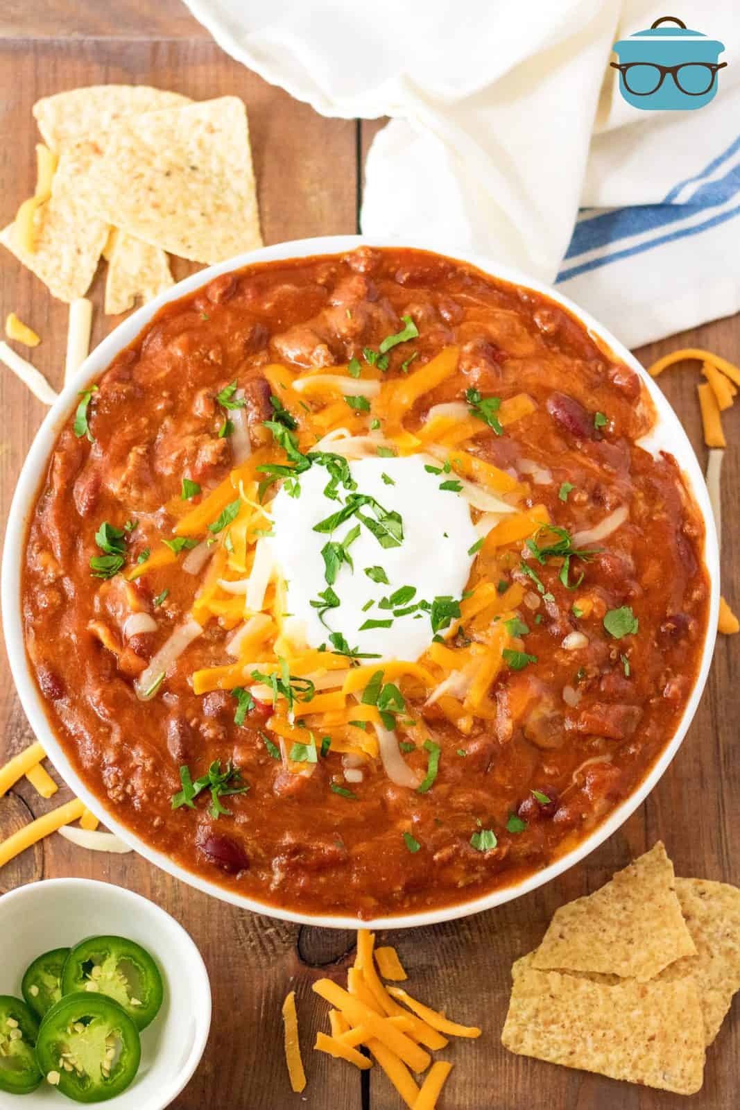 Overhead of garnished bowl of Slow Cooker Ultimate Beef Chili.