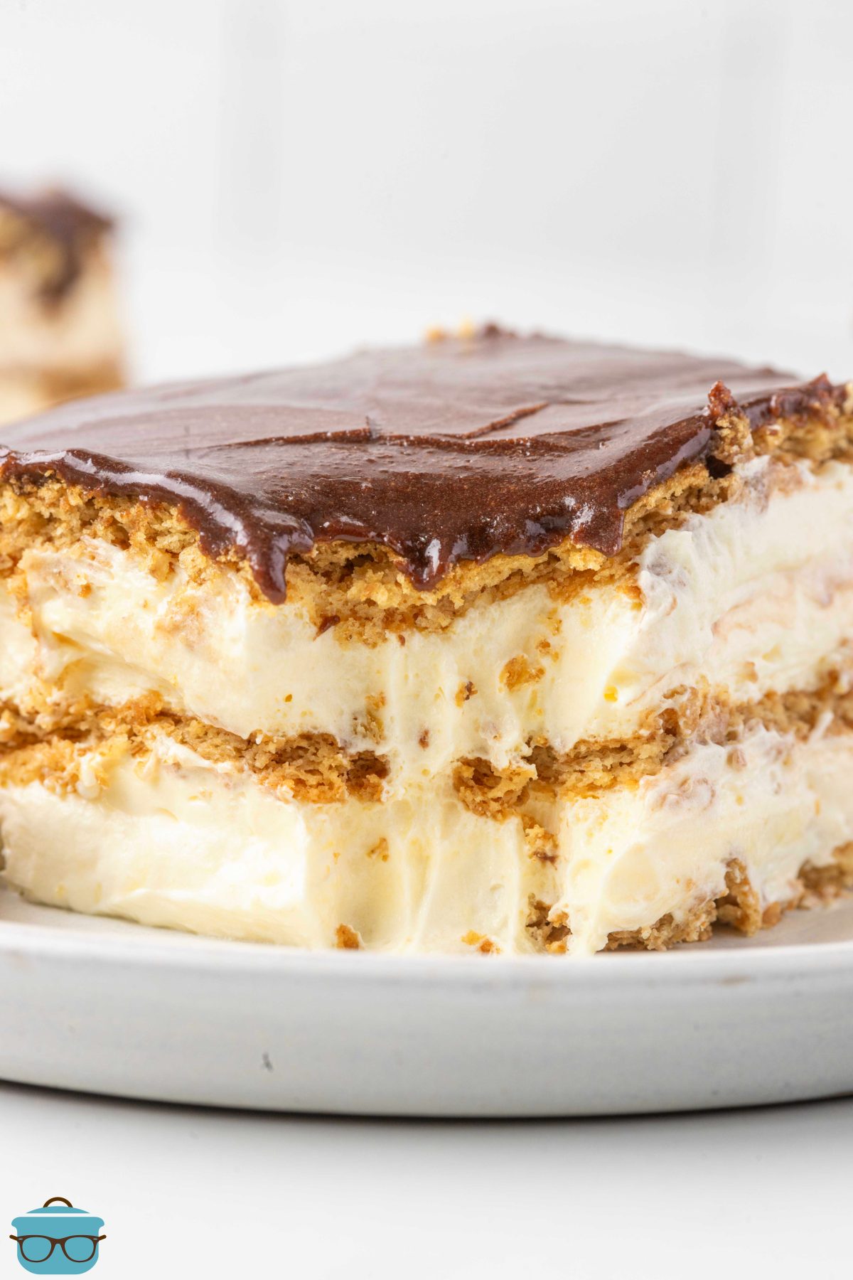 A slice of Eclair Cake with a bite missing on a dessert plate.