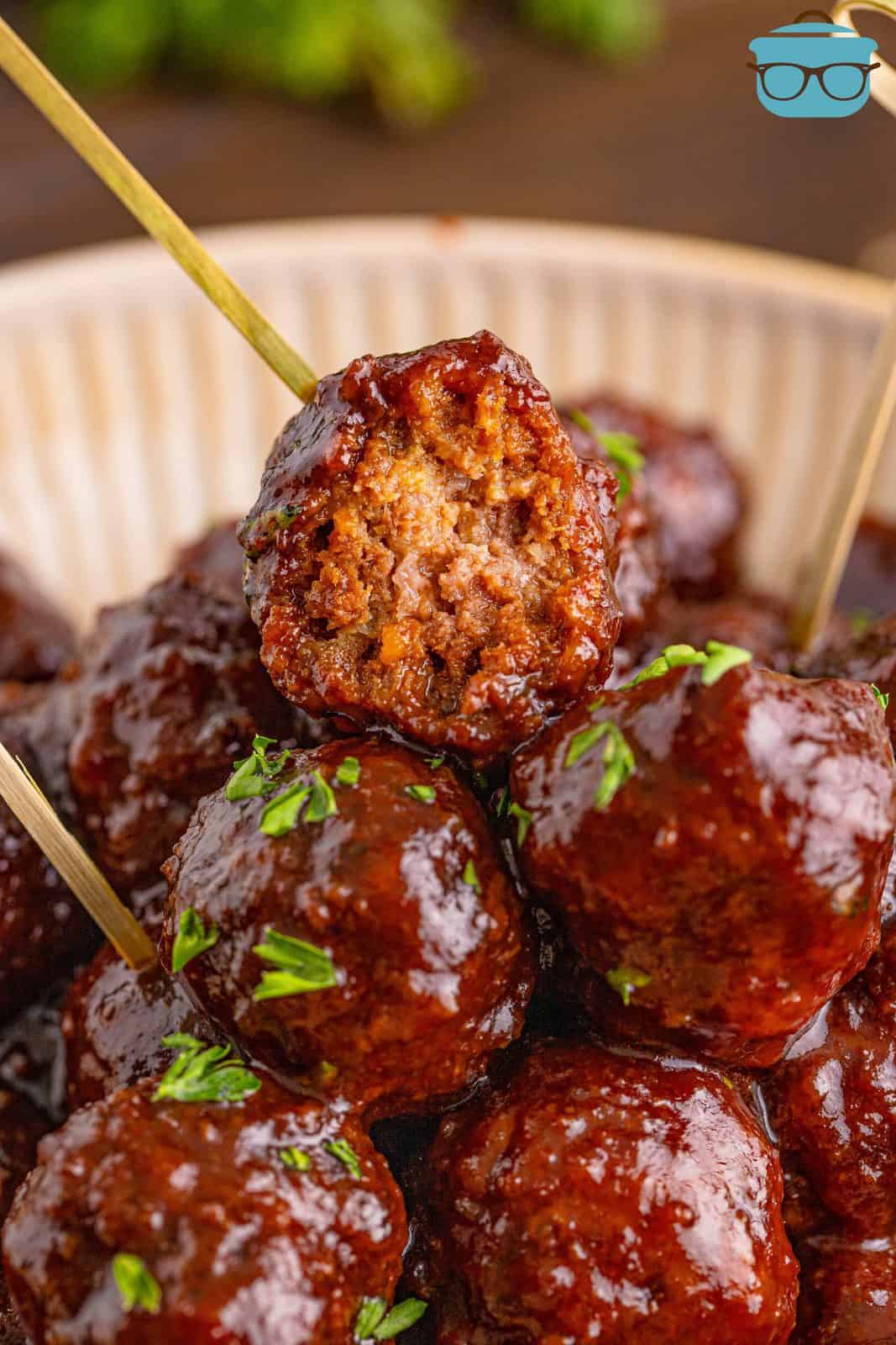 Stacked Homemade Grape Jelly Meatballs with bite taken out of one.