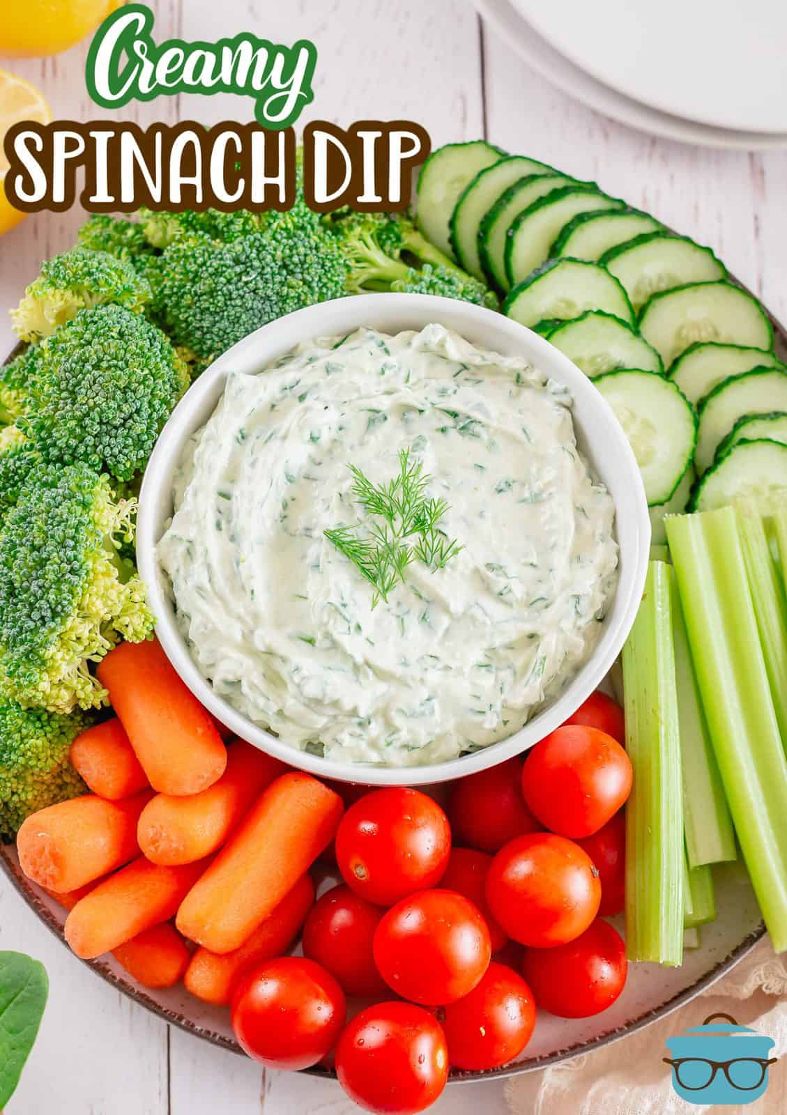 Pinterest image of Spinach Dip in white bowl in center of various vegeables.