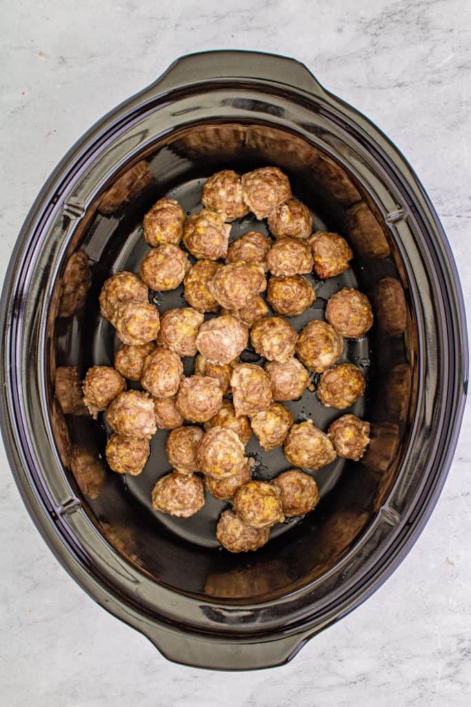 Meatballs placed in crock pot.