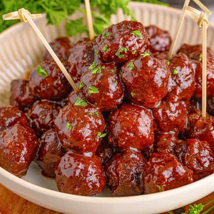 Square image of Homemade Grape Jelly Meatballs in dish with toothpicks.