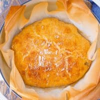 Square image of bread in dutch oven.