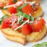 Square image close up of Parmesan Bruschetta on baguette.