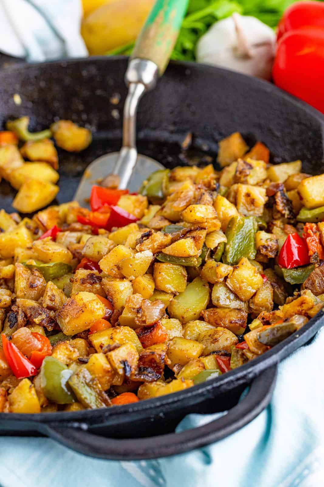 Southern Home Fries in skillet with spatula.