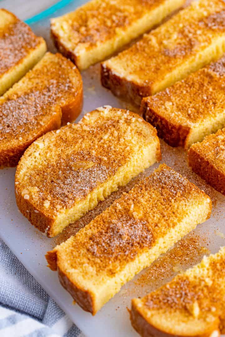 slices of French Toast shown on a platter and sprinkled with cinnamon,on sugar