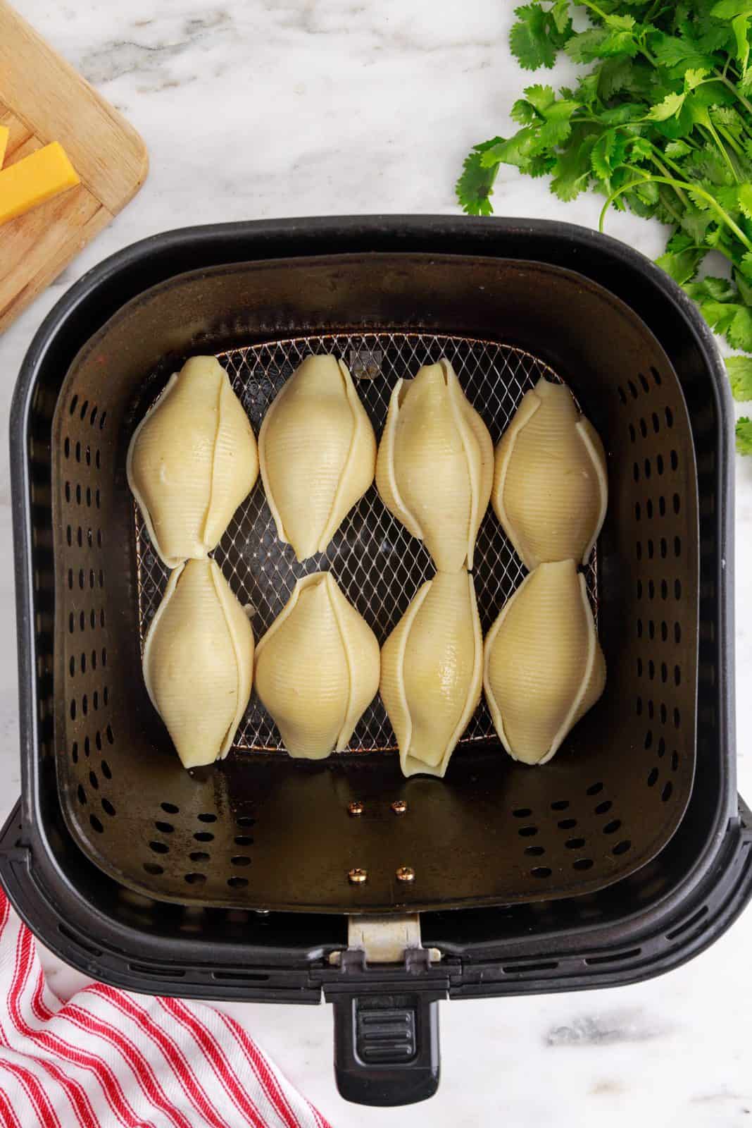 Stuffed Shells placed in air fryer.