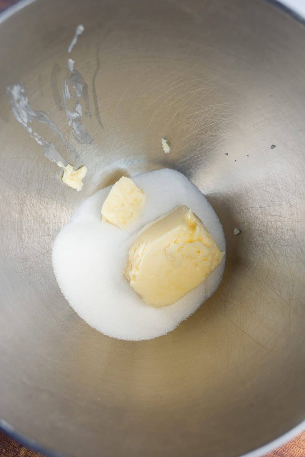 Butter and sugar in bowl of stand mixer.