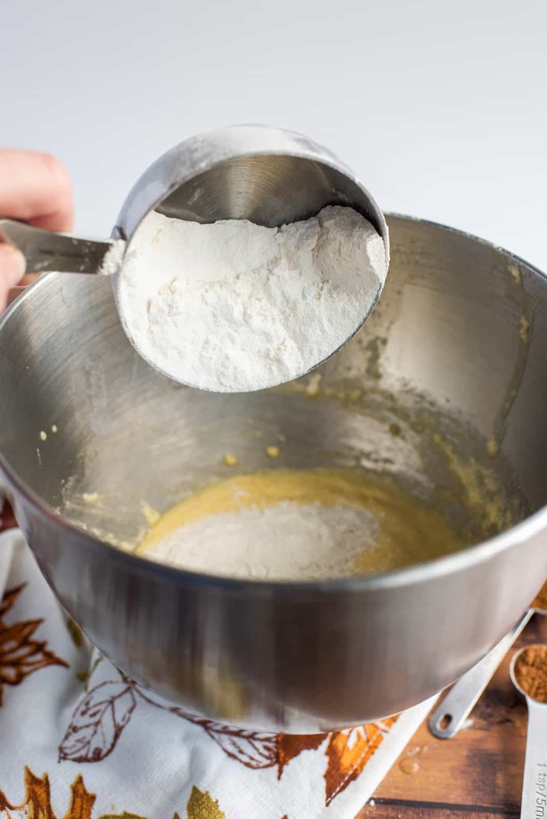 Flour being added to bowl of stand mixer.
