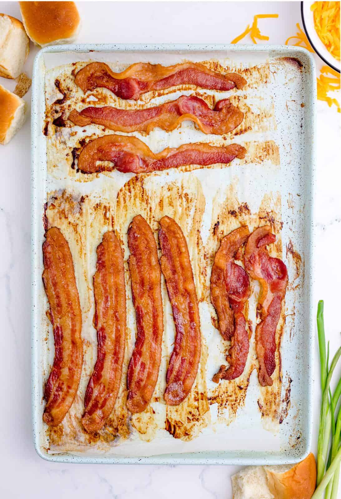 Cooked bacon on baking sheet.