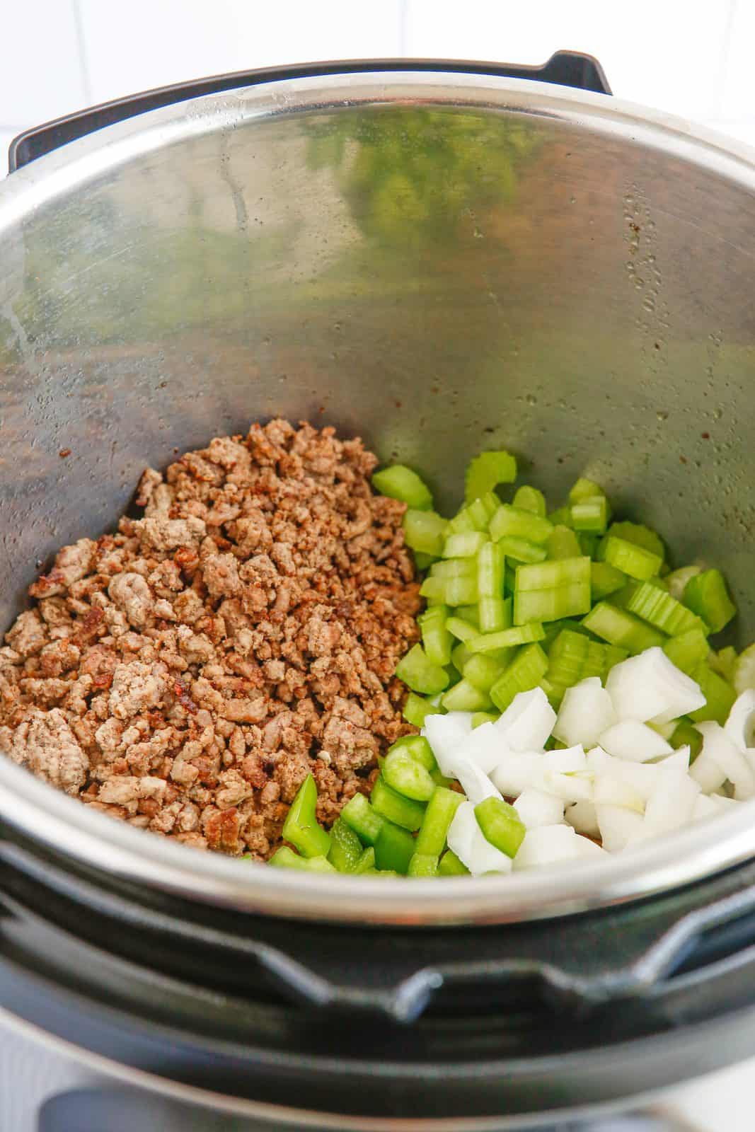 Vegetables added to ground beef in instant pot.