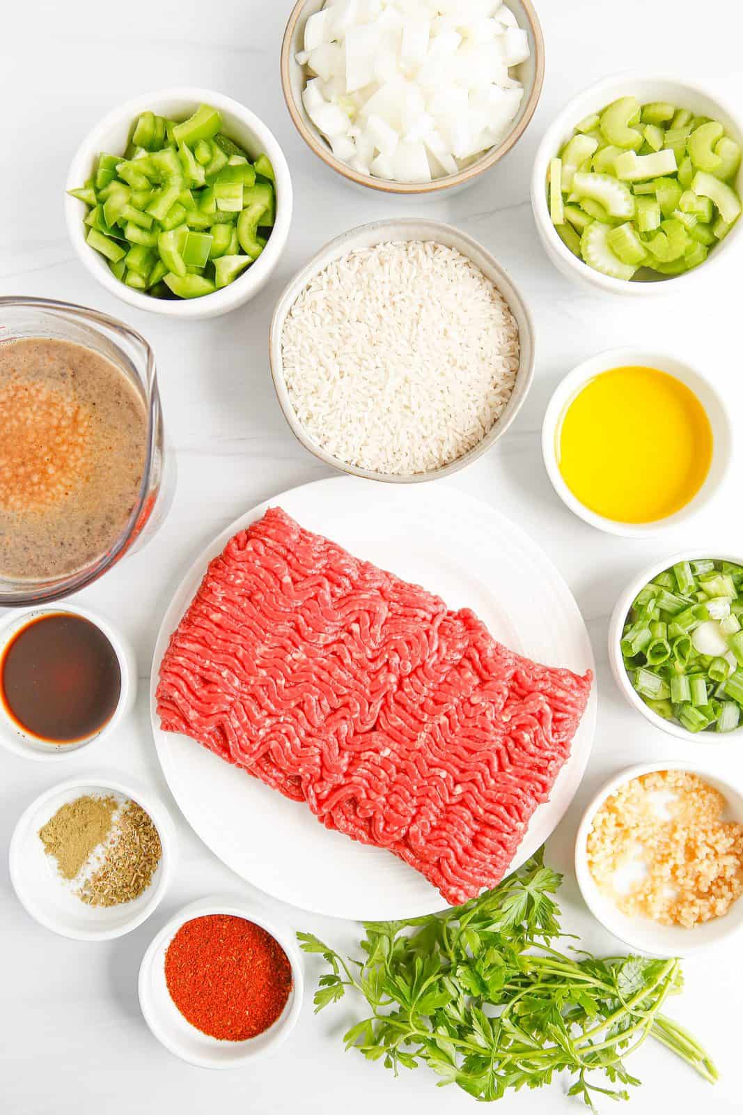 Ingredients needed: ground beef, olive oil, yellow onion, green bell pepper, celery, garlic, thyme, oregano, creole seasoning, worcestershire sauce, salt, pepper, long grain white rice, beef broth, bay leaf, green onions and parsley.