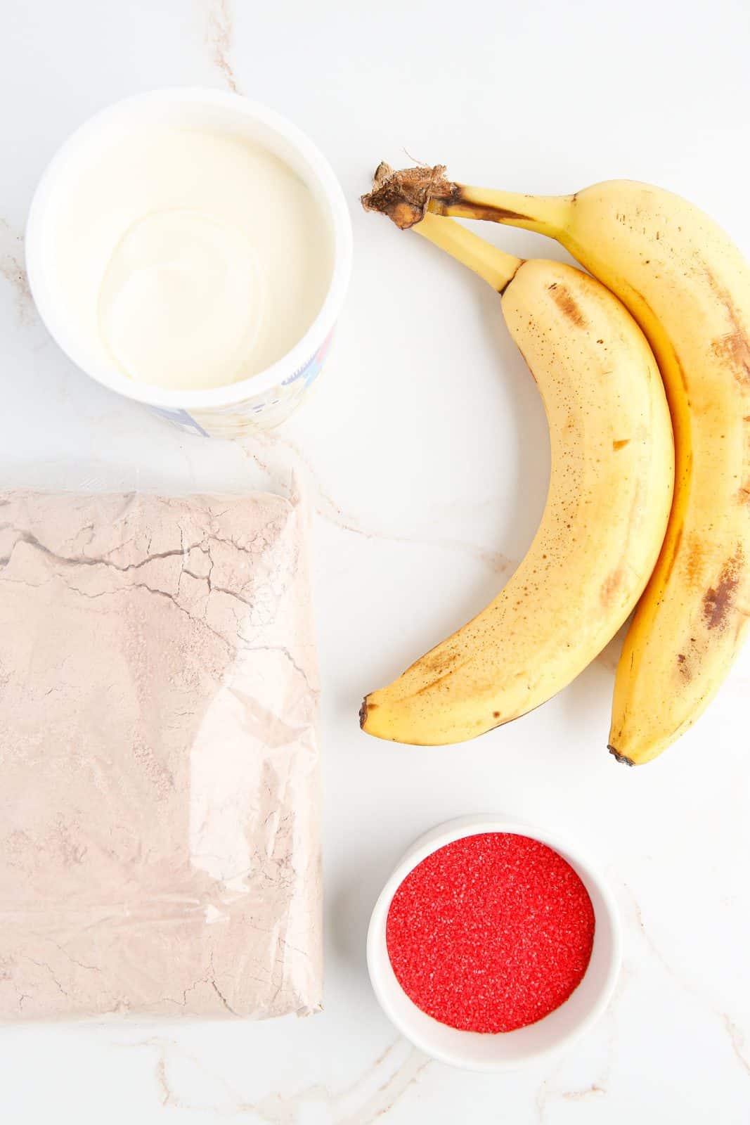 Ingredients needed: red velvet cake mix, bananas, cream cheese frosting and red sugar sprinkles.