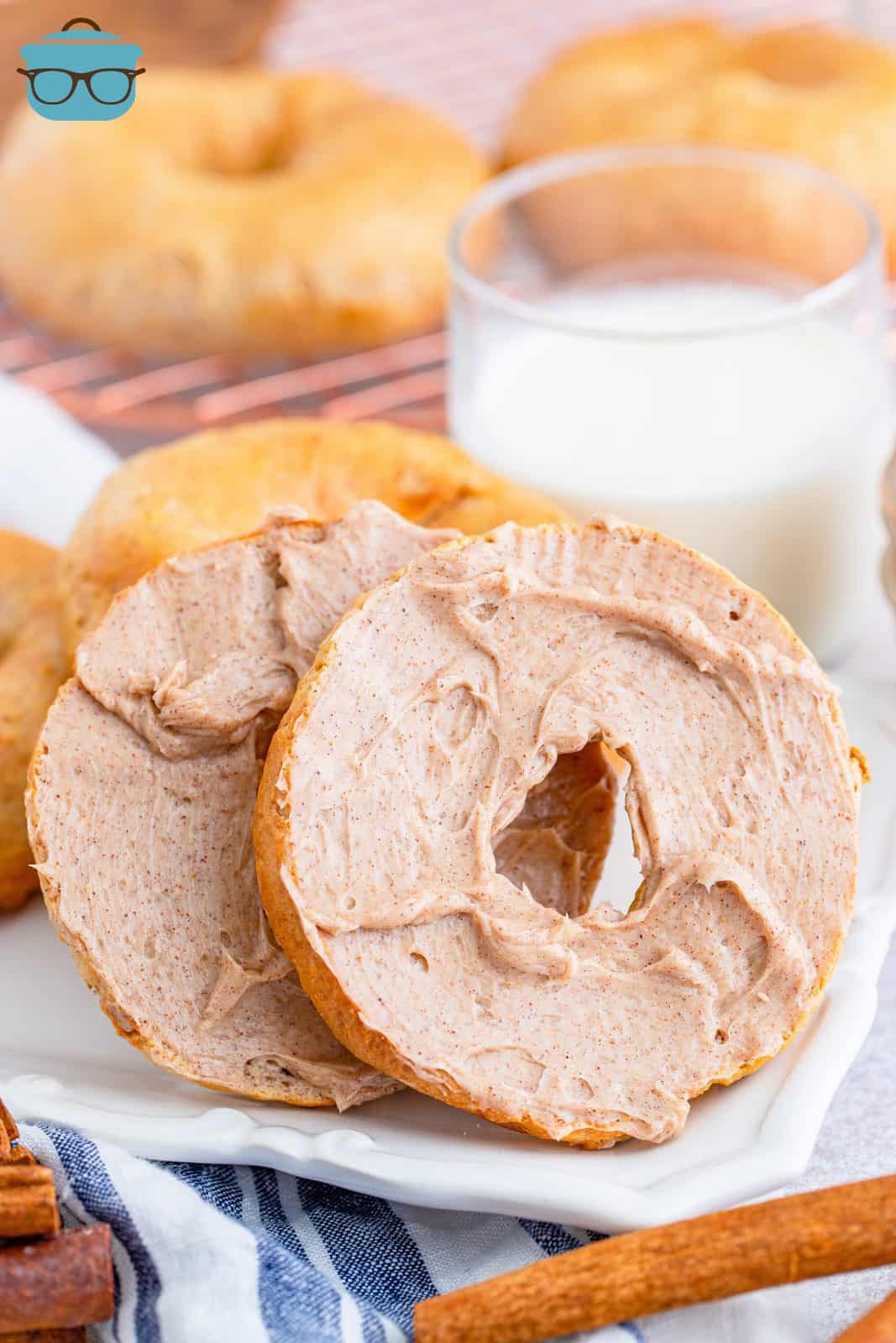 Two slices of Air Fryer Cinnamon Bagels spread with cinnamon honey butter.