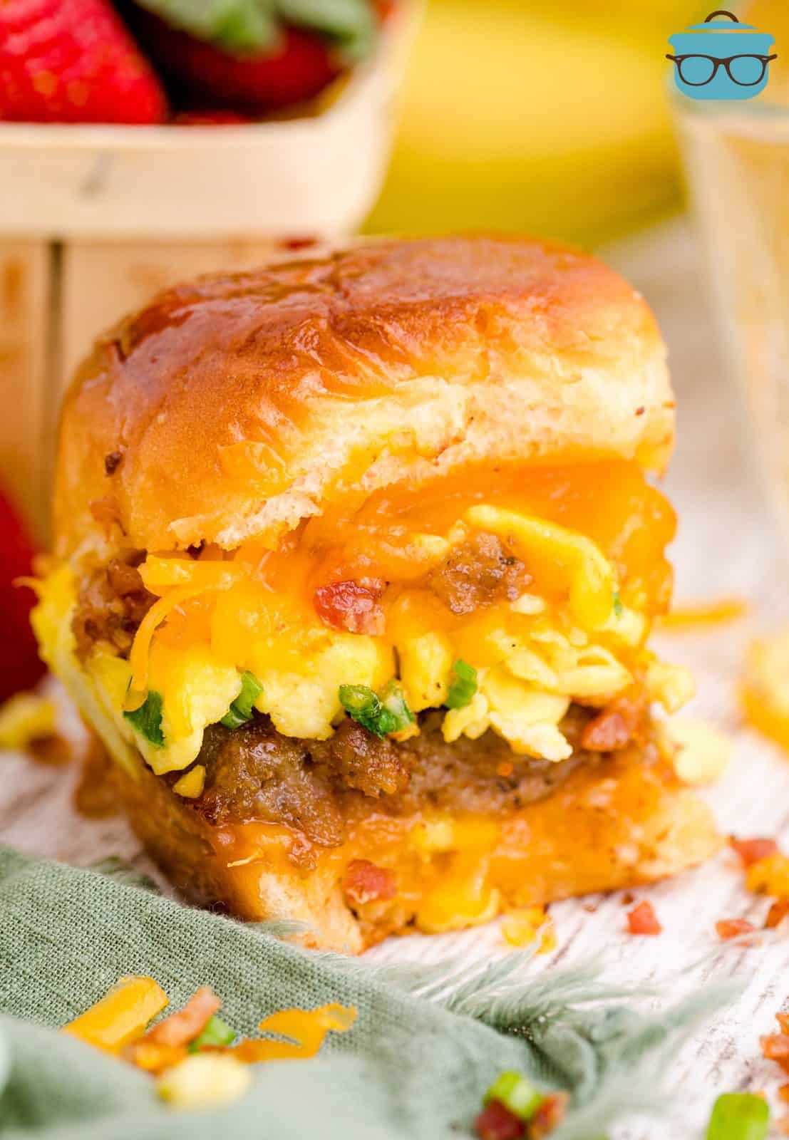 One Breakfast Slider on board showing the layers meat, egg and cheese.