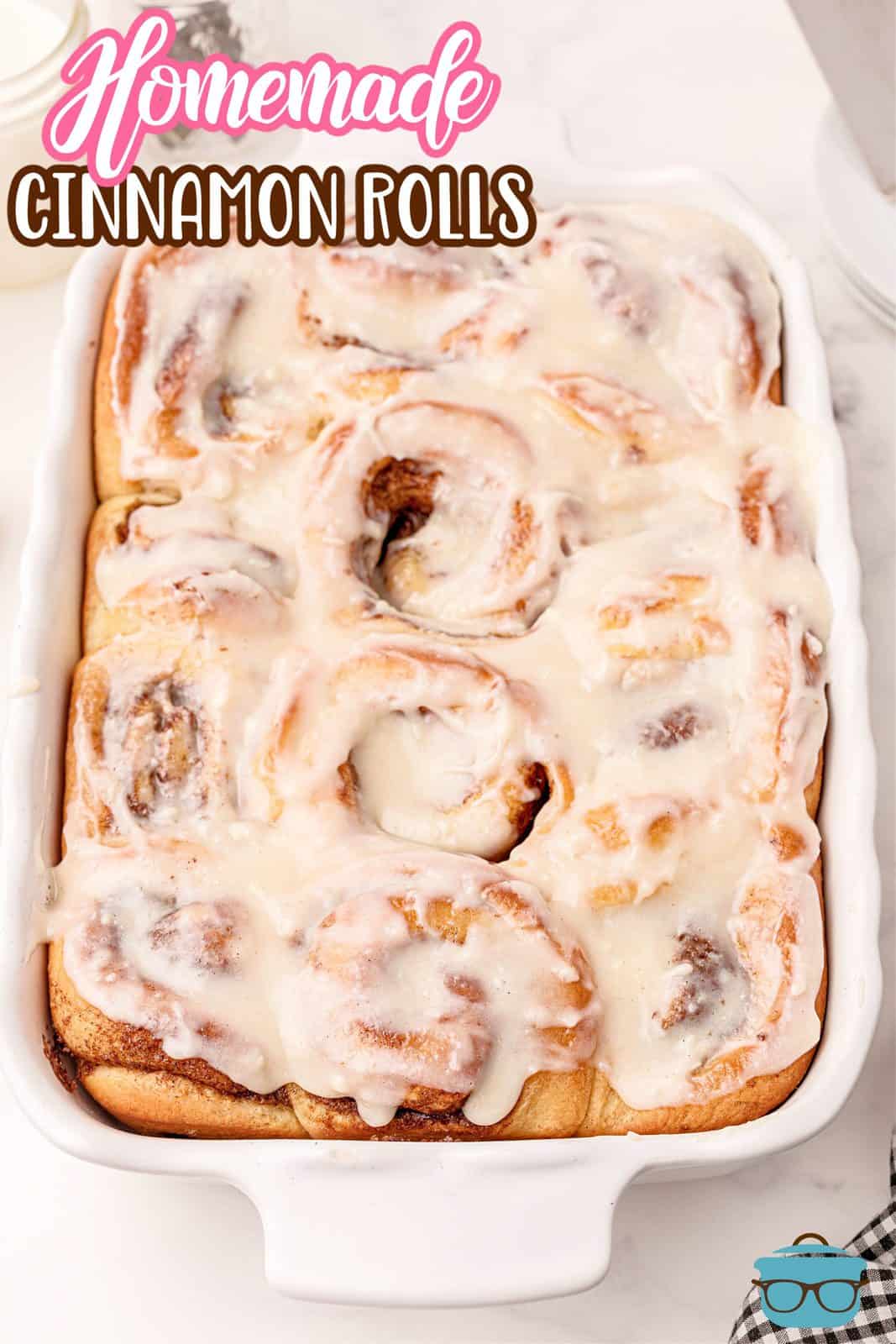 Pinterest image of Homemade Cinnamon Rolls in pan at angle showing icing.