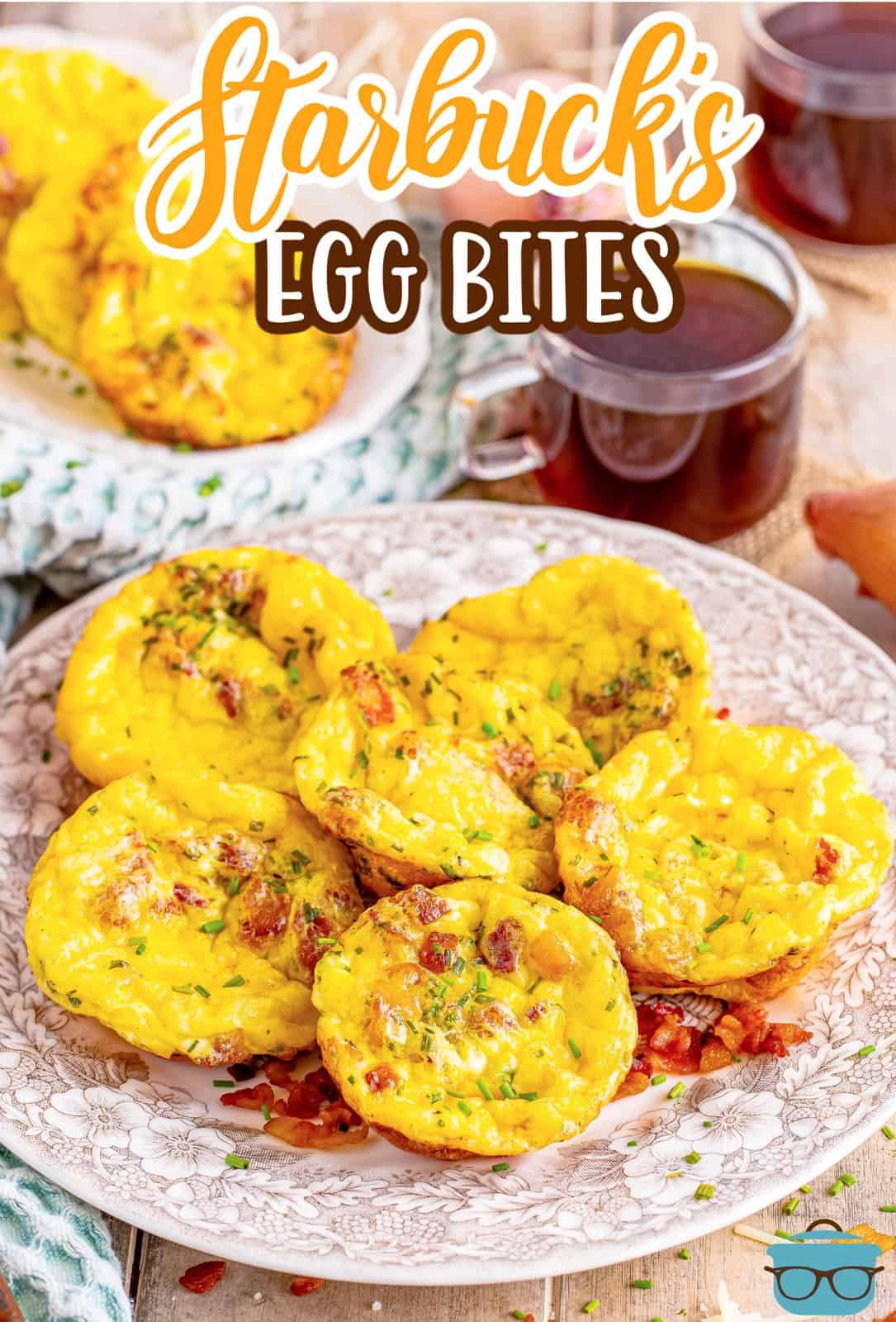 a stack of egg bites on a brown and white floral plate with a clear cup of coffee in the background.