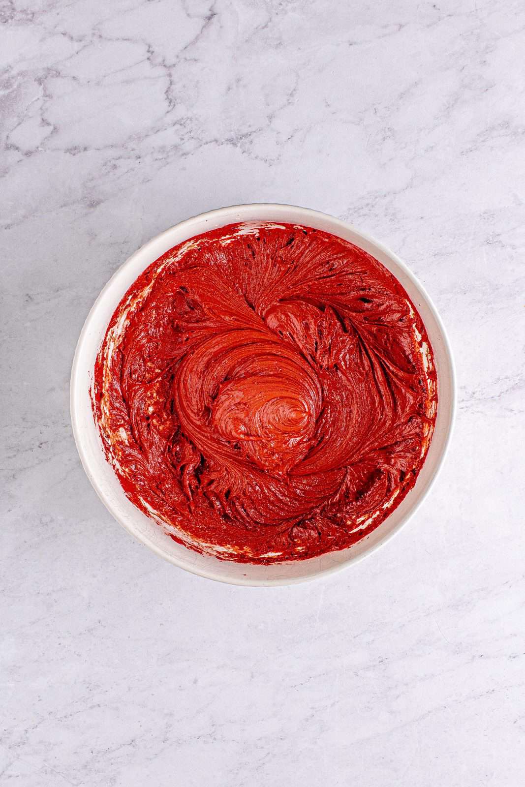 Red velvet cake mix blended together in bowl.
