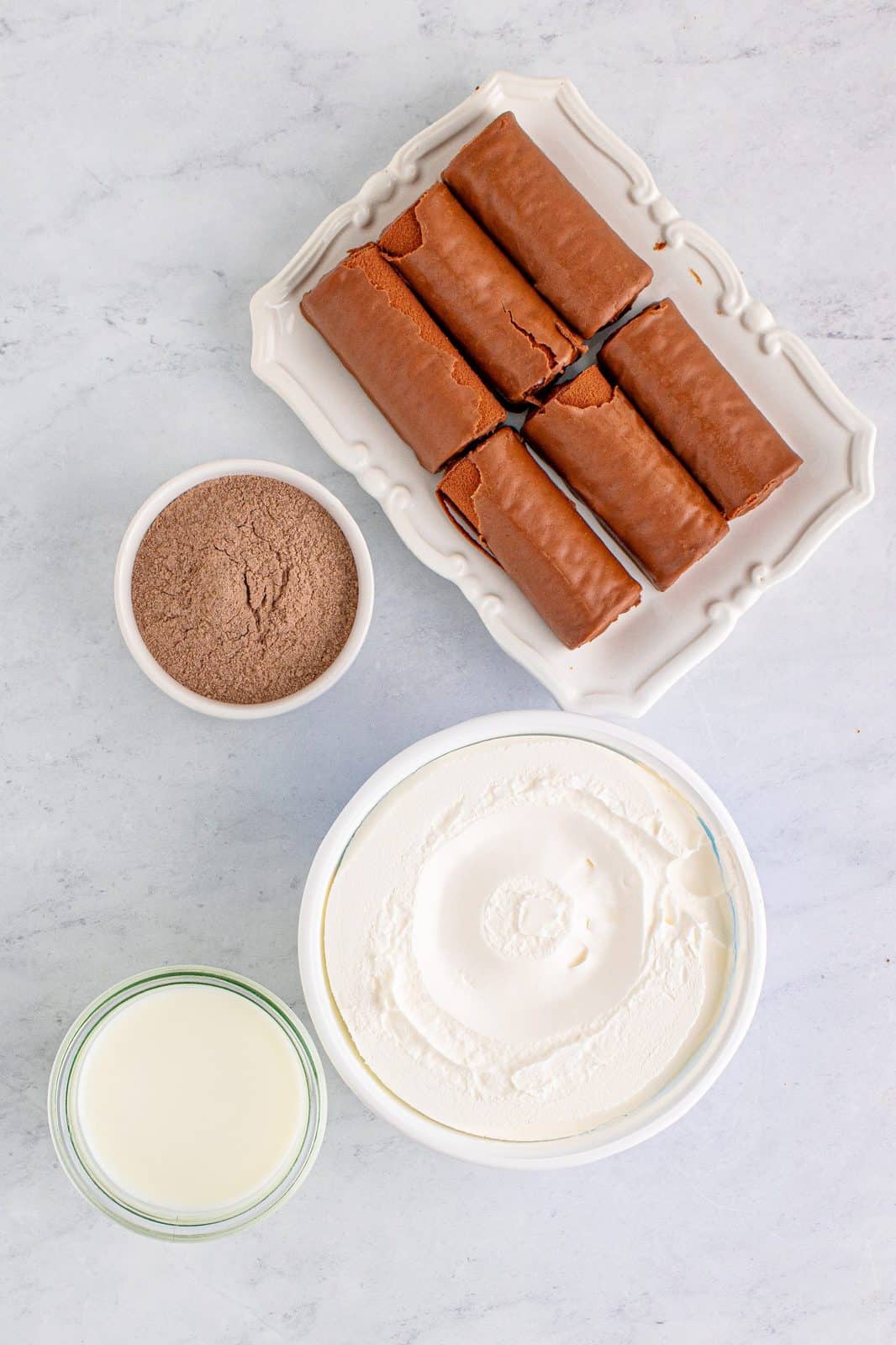 Ingredients needed: instant chocolate pudding mix, whole milk, cool whip and swiss cake rolls.