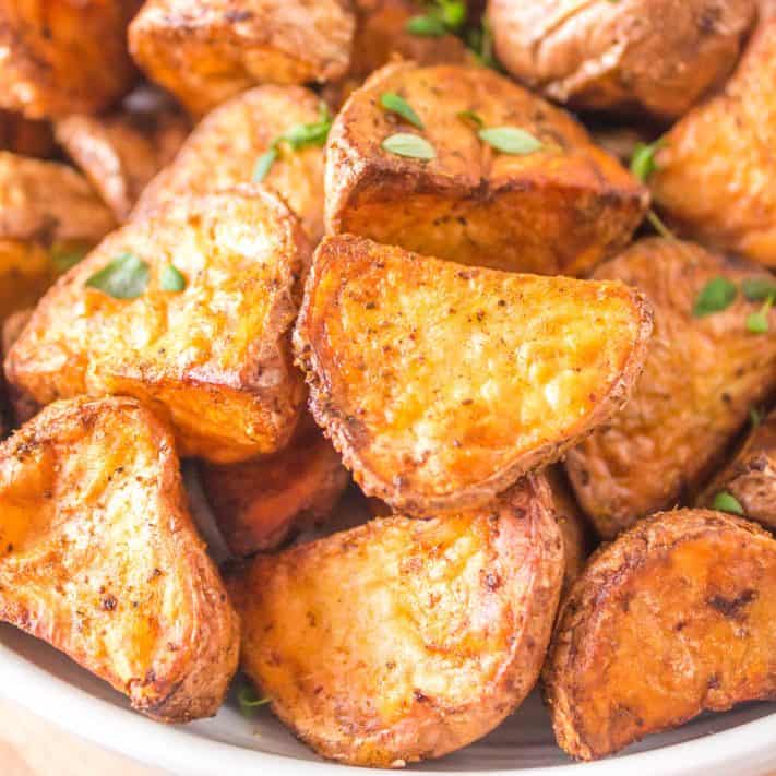 Close up square image of Air Fryer Roasted Red Potatoes in bowl.