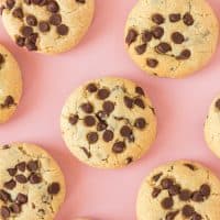Square image of Chocolate Chip Cream Cheese Cookies on pink background.