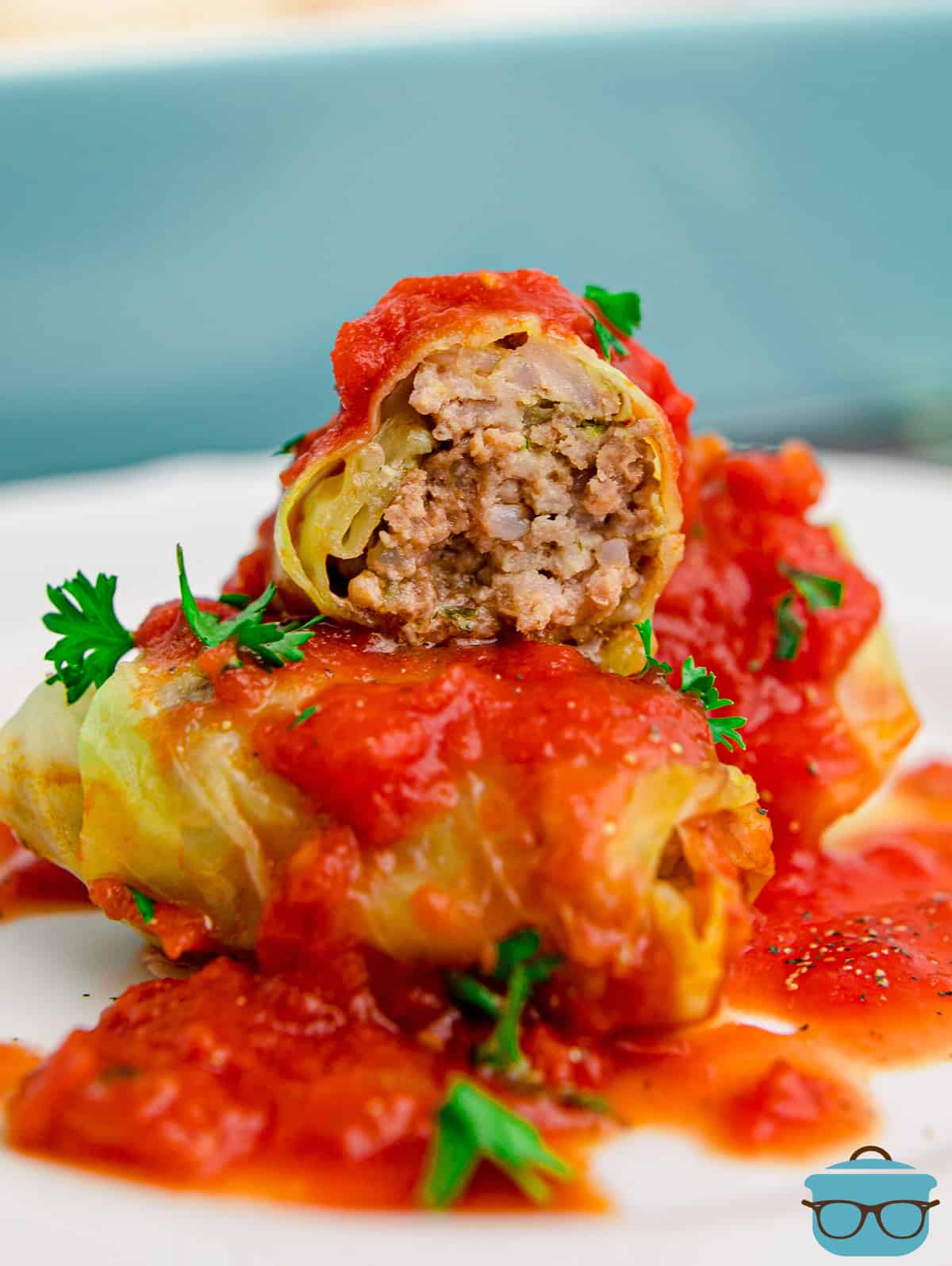 Cabbage Rolls on plate with top one cut open showing filling.