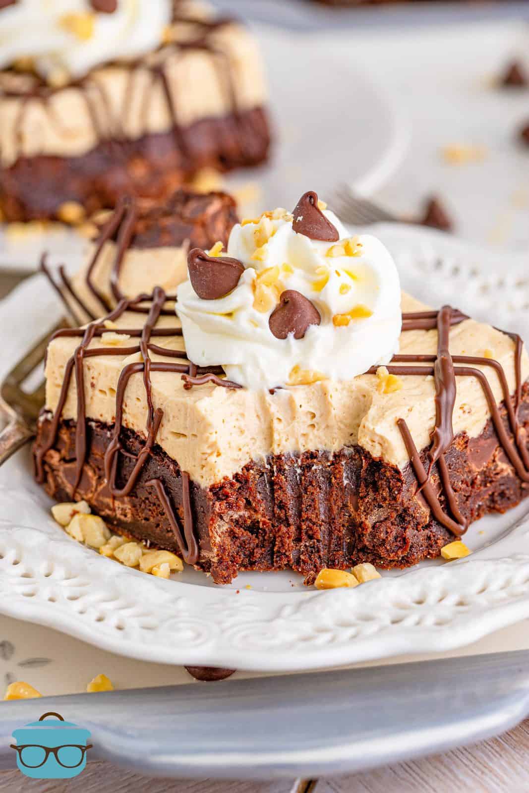 Peanut Butter Pie Brownies on plate with bite taken out of it.